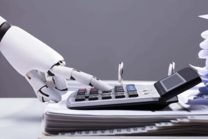 Close-up Of A Robotic Hand Calculating Bills Using Calculator In Office